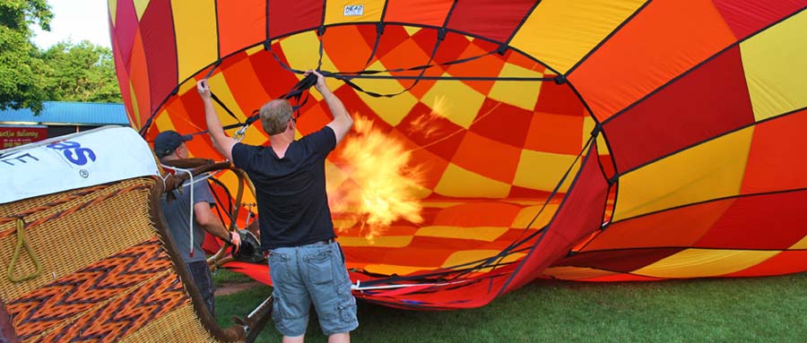 man inflating a hot air balloon