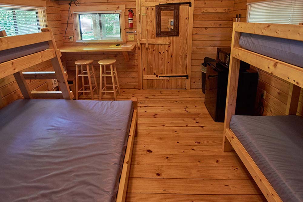 inside of cabin with four bunkbeds and sitting area